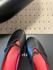 BOTTEGA VENETA 26S FLAT MULES IN BLACK LAMBSKIN