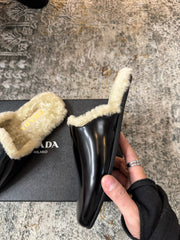 PRADA 25S CLOGS IN BLACK CALFSKIN AND BEIGE FUR-LINED