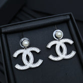 DOUBLE C EARRINGS IN SILVER METAL WITH BLACK SNOWFLAKE EMBOSSED ON WHITE ENAMEL