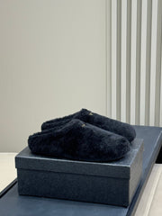 PRADA 25S CLOGS IN BLACK SHEARLING