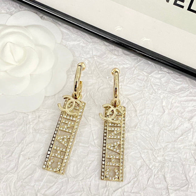 CC TEXT DIAMOND PAVED LIGHT GOLD DROP EARRINGS