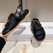 CROSS STRAP SANDAL IN BLACK RUBBER WITH GOLD HARDWARE