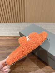 FURRY SLIDES IN ORANGE CURLY SHEARLING