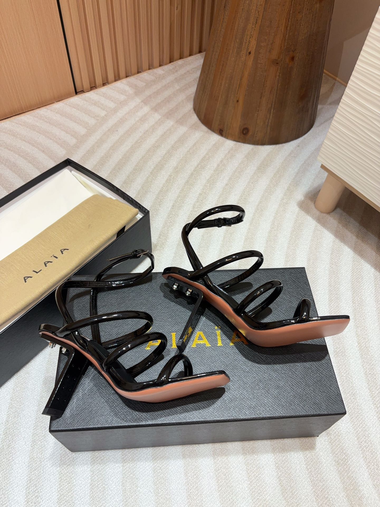 ALAIA THREE-STRAPS HIGH HEEL SANDALS IN BLACK PATENT LAMBSKIN