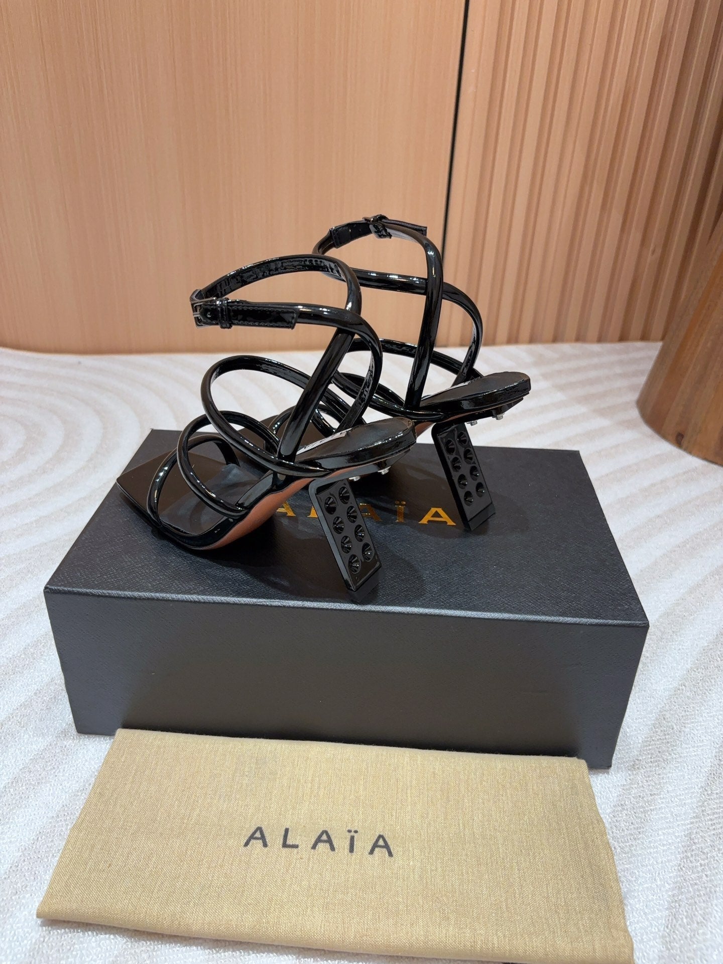 ALAIA THREE-STRAPS HIGH HEEL SANDALS IN BLACK PATENT LAMBSKIN