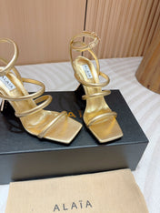 ALAIA THREE-STRAPS HIGH HEEL SANDALS IN GOLDEN PATENT LAMBSKIN
