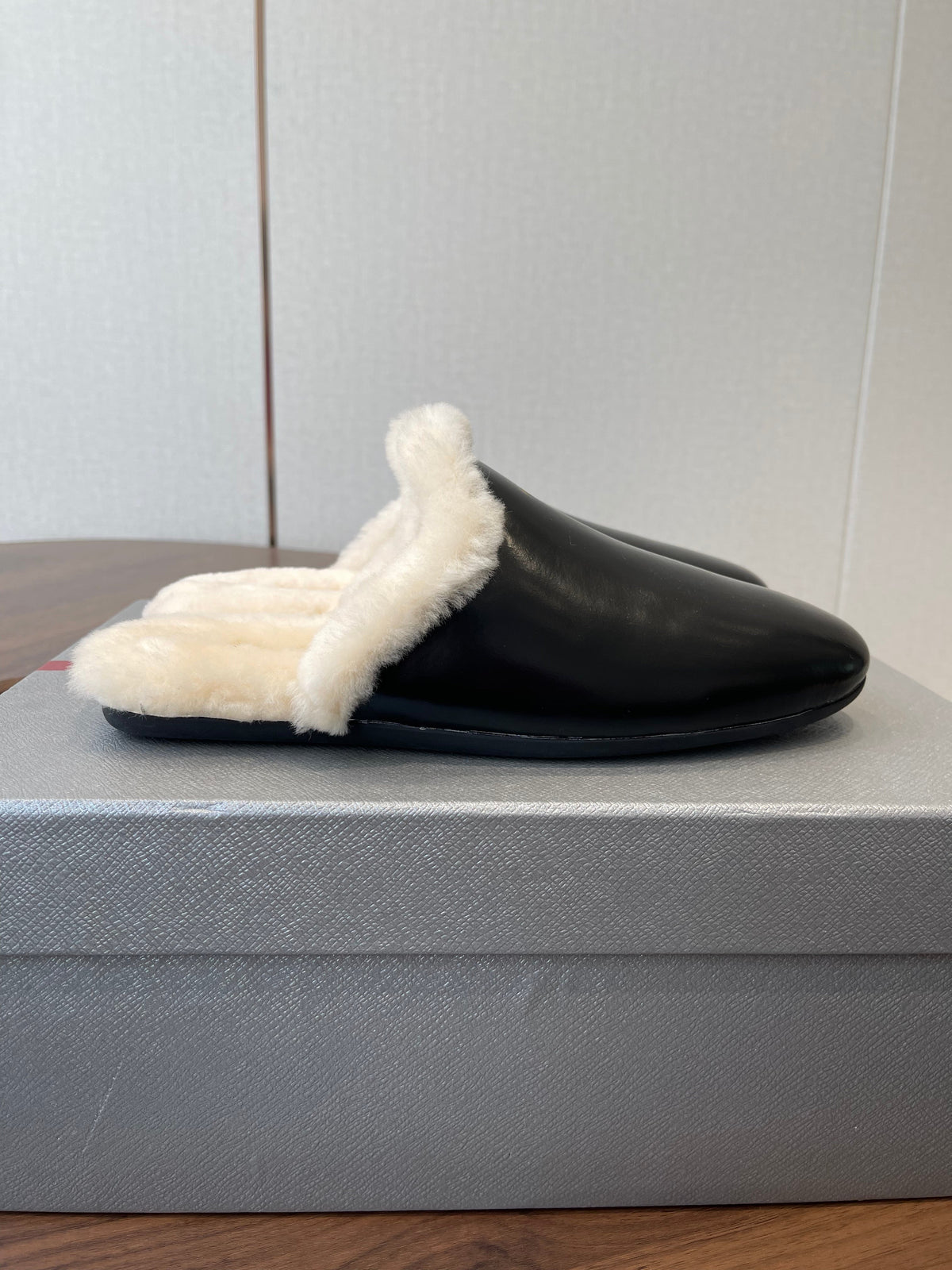 PRADA 25S CLOGS IN BLACK CALFSKIN FUR-LINED