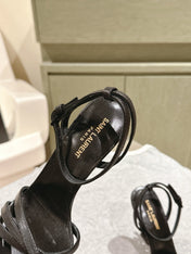 YSL 25S HIGH-HEEL SANDALS 100 MM IN BLACK LAMBSKIN WITH YSL LOGO HEEL DESIGN