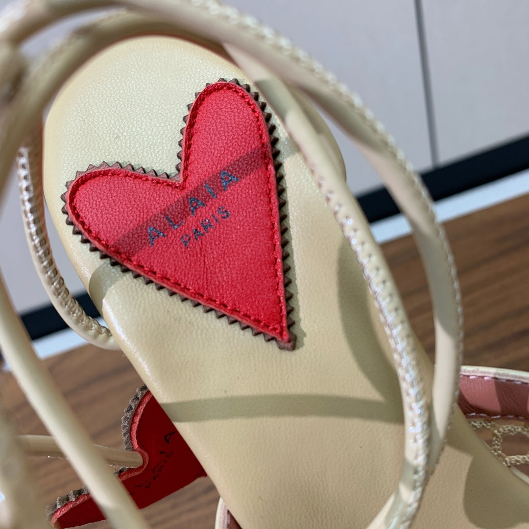 ALAIA BANQUET WEDGE SANDALS IN GOLD LAMBSKIN WITH RED HEART