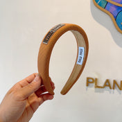 THICK HEADBAND IN BRONZE ORANGE DIAGONAL LEATHER 425479