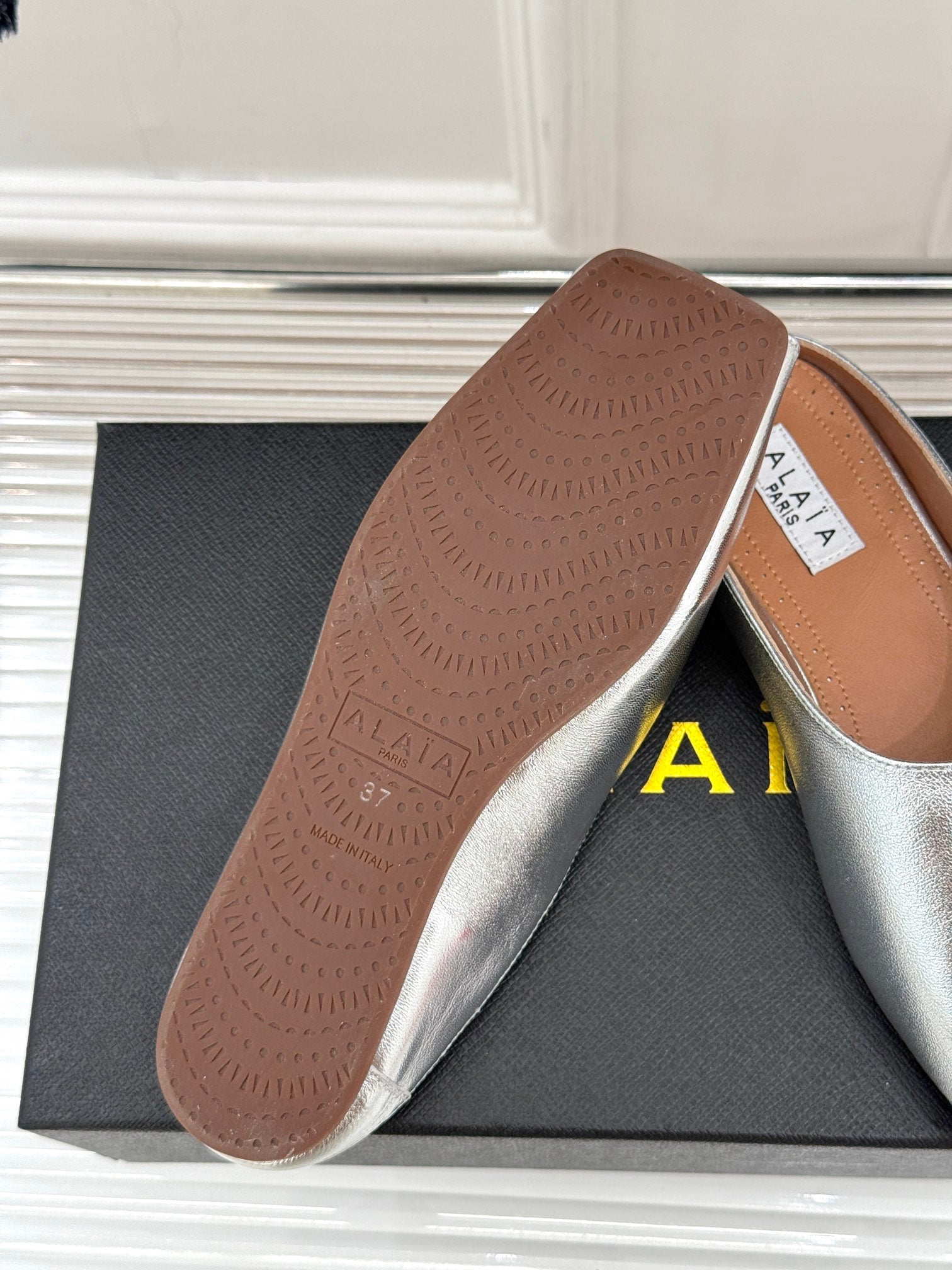 ALAIA FLAT MULE IN SILVER LAMBSKIN