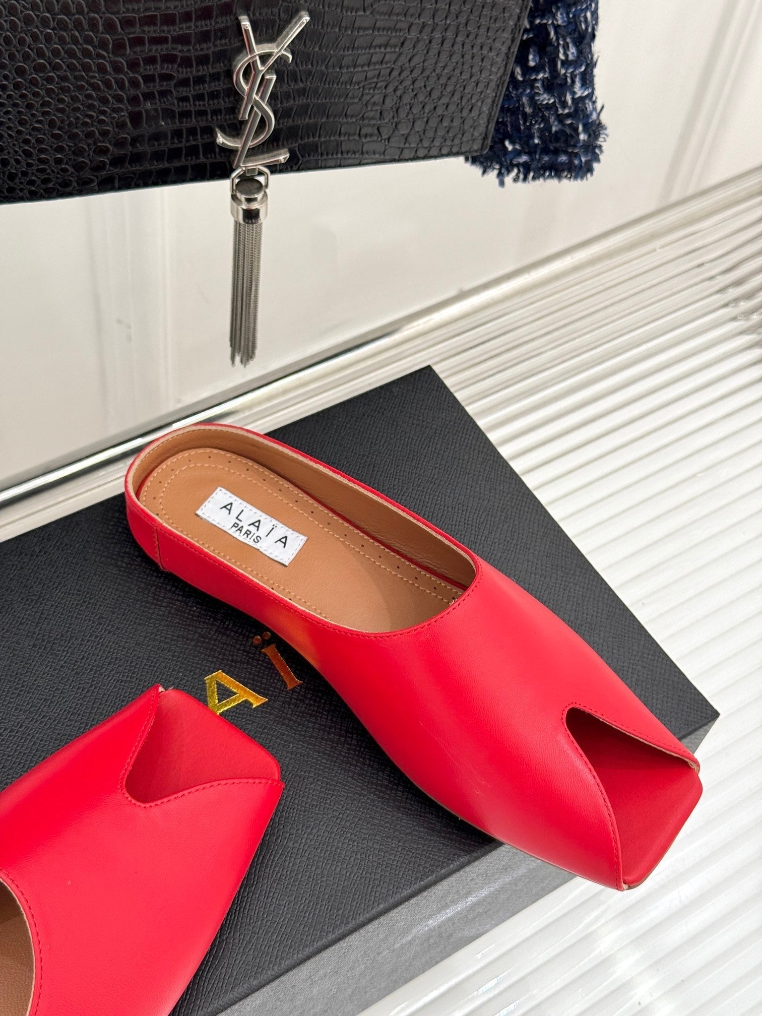 ALAIA FLAT MULE IN CRIMSON RED LAMBSKIN