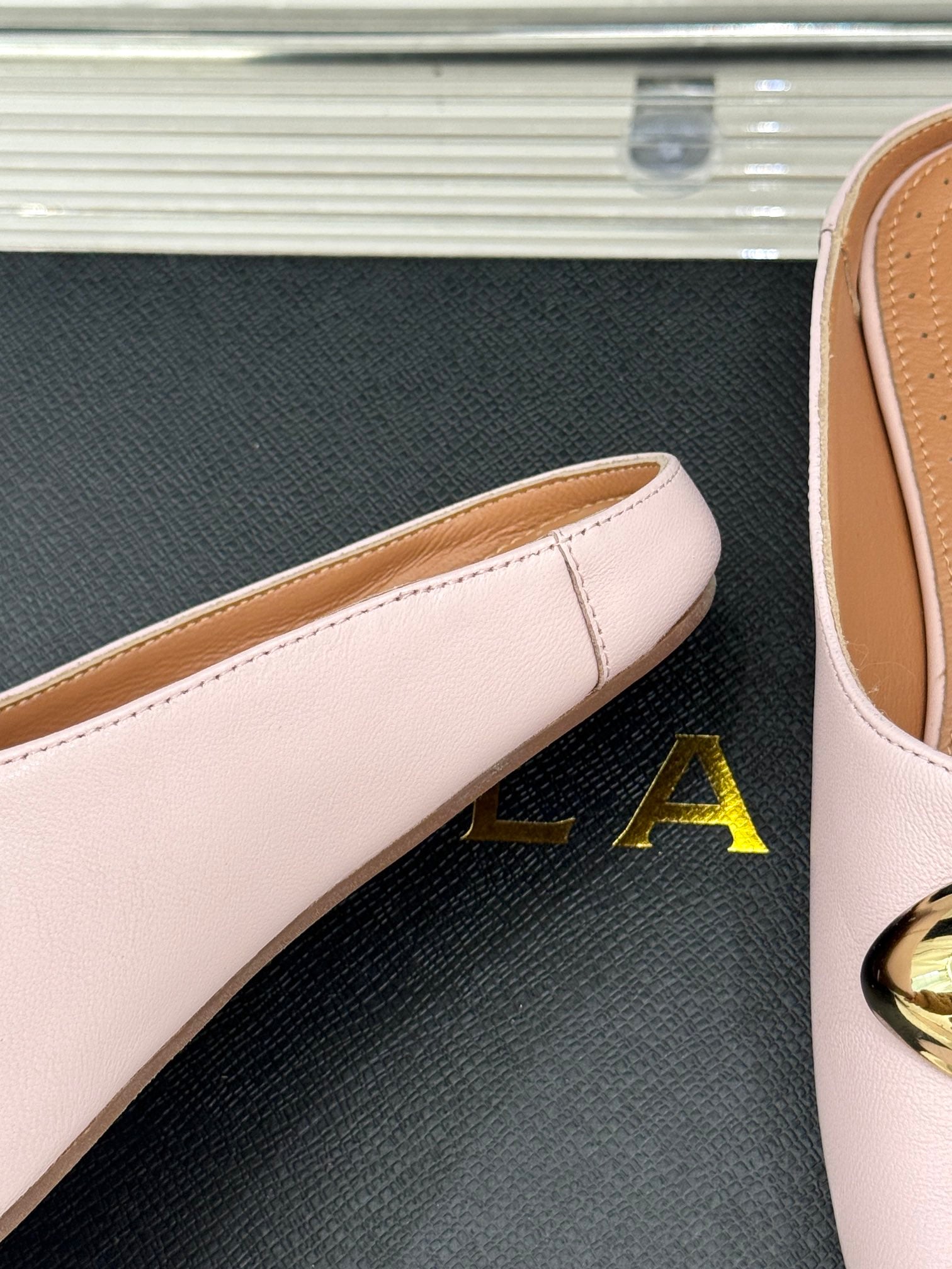 ALAIA FLAT MULE IN LIGHT PINK LAMBSKIN WITH GOLD HARDWARE
