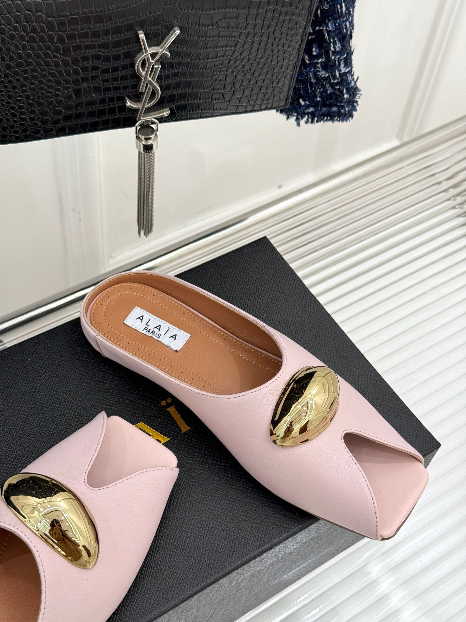 ALAIA FLAT MULE IN LIGHT PINK LAMBSKIN WITH GOLD HARDWARE