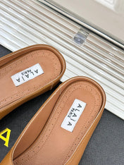 ALAIA FLAT MULE IN BRONZE BROWN LAMBSKIN WITH GOLD HARDWARE