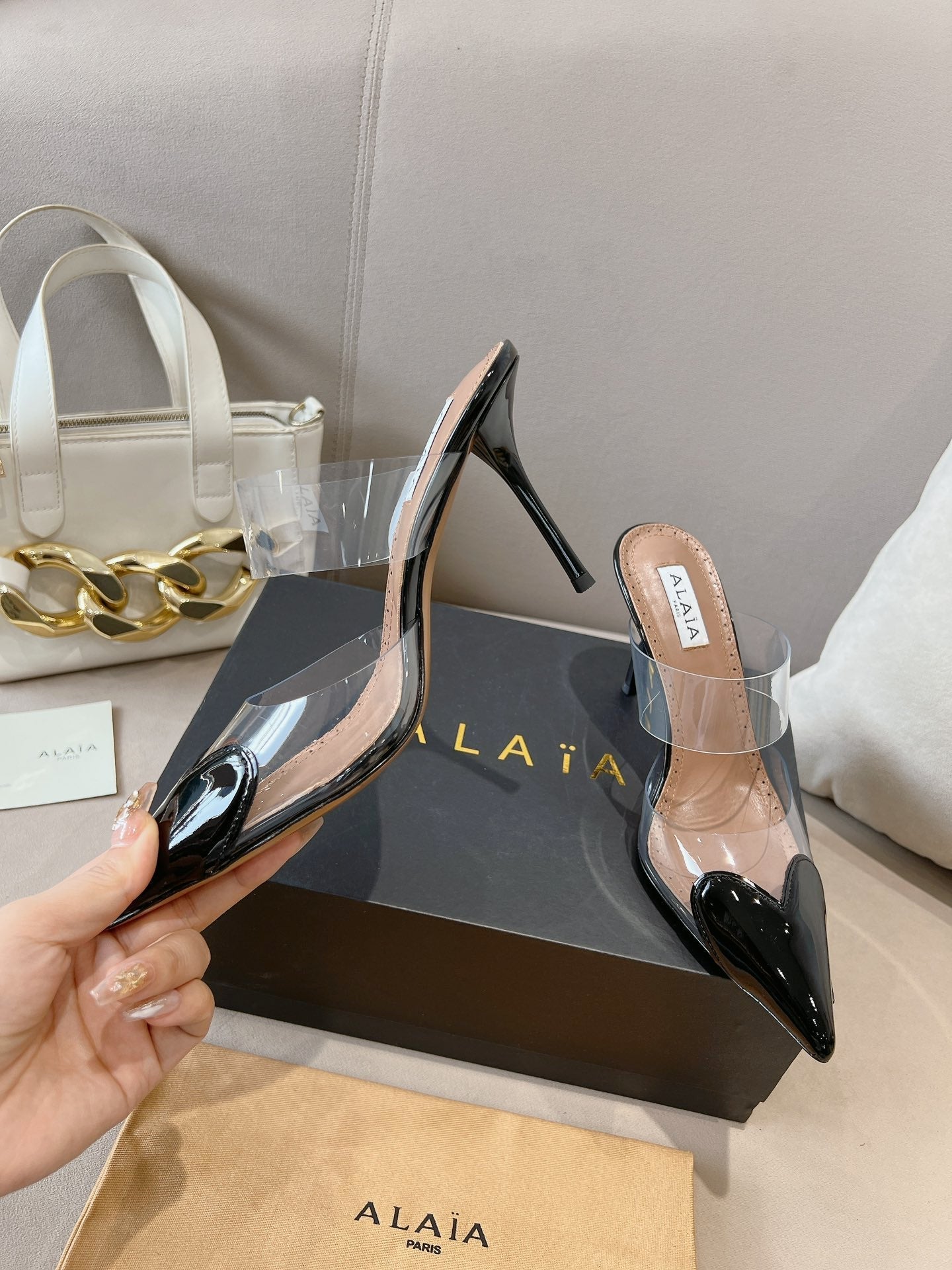ALAIA HIGH MULES IN BLACK PATENT CALFSKIN AND FILM