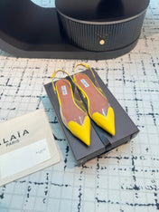 ALAIA FLAT SLINGBACK IN YELLOW PATENT CALFSKIN AND FILM