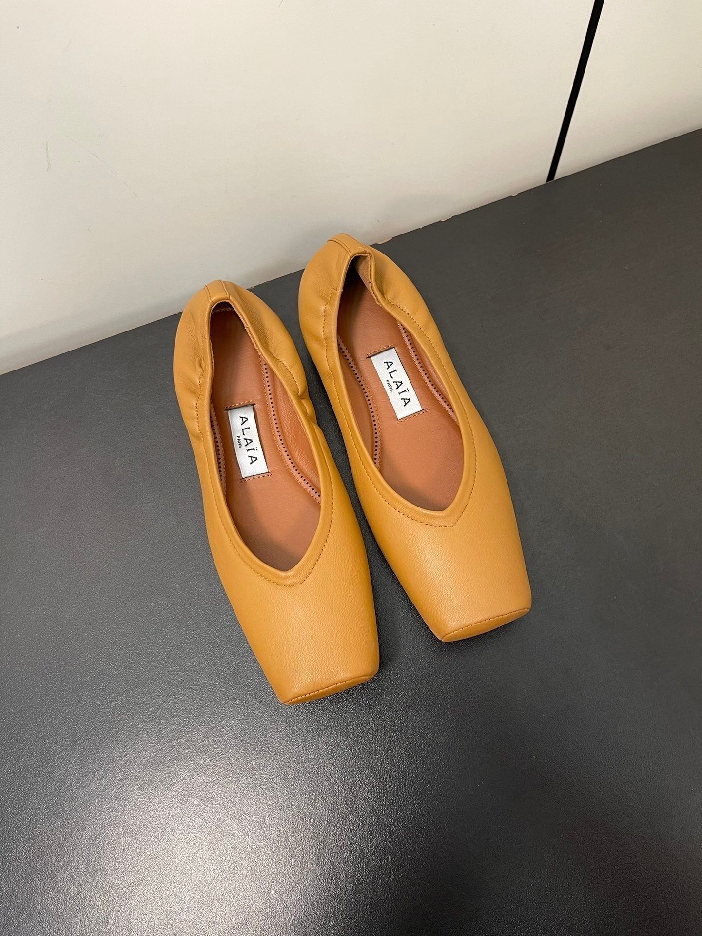 ALAIA BALLET FLATS IN COPPER BROWN SMOOTH CALFSKIN