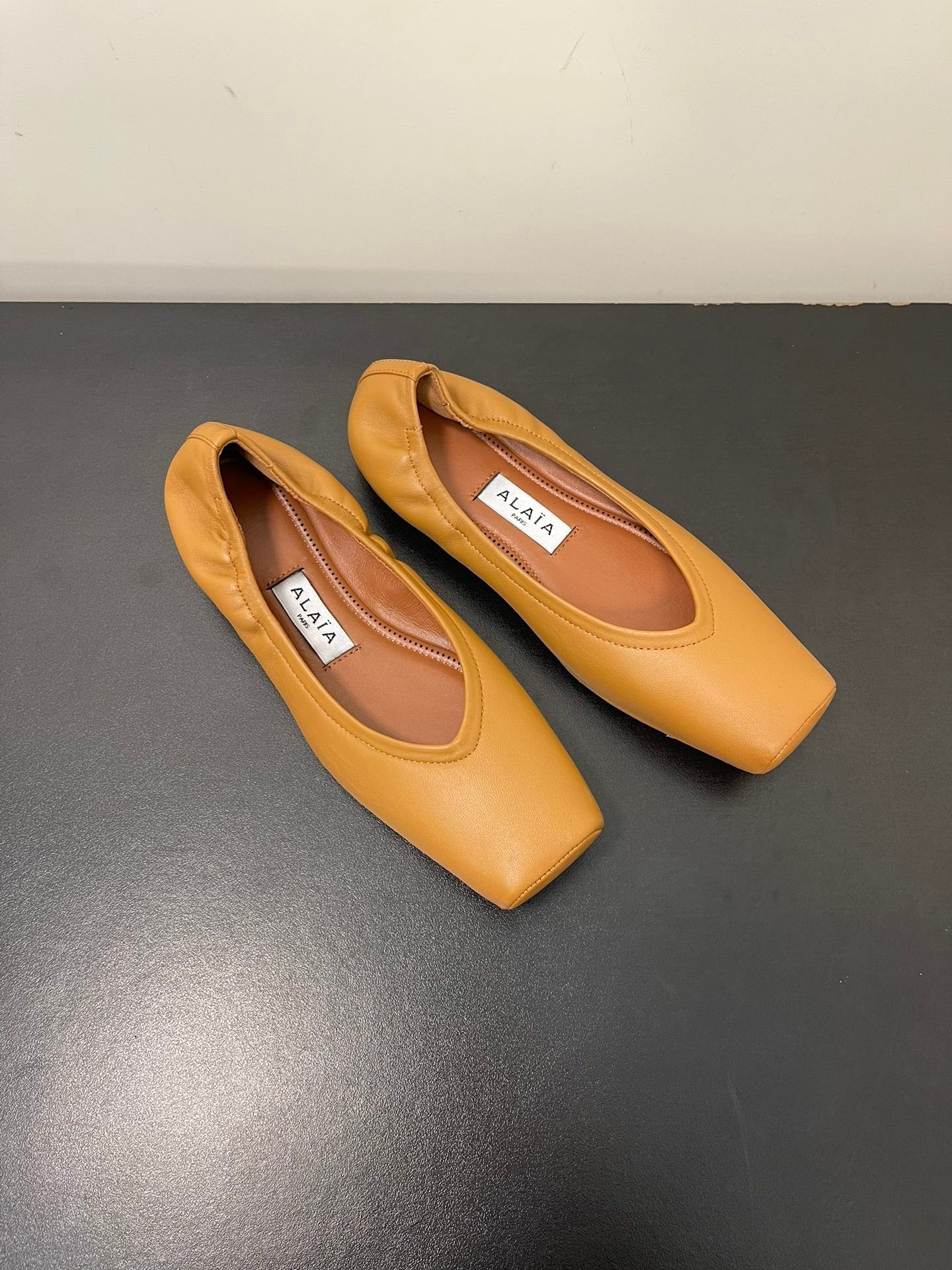 ALAIA BALLET FLATS IN COPPER BROWN SMOOTH CALFSKIN
