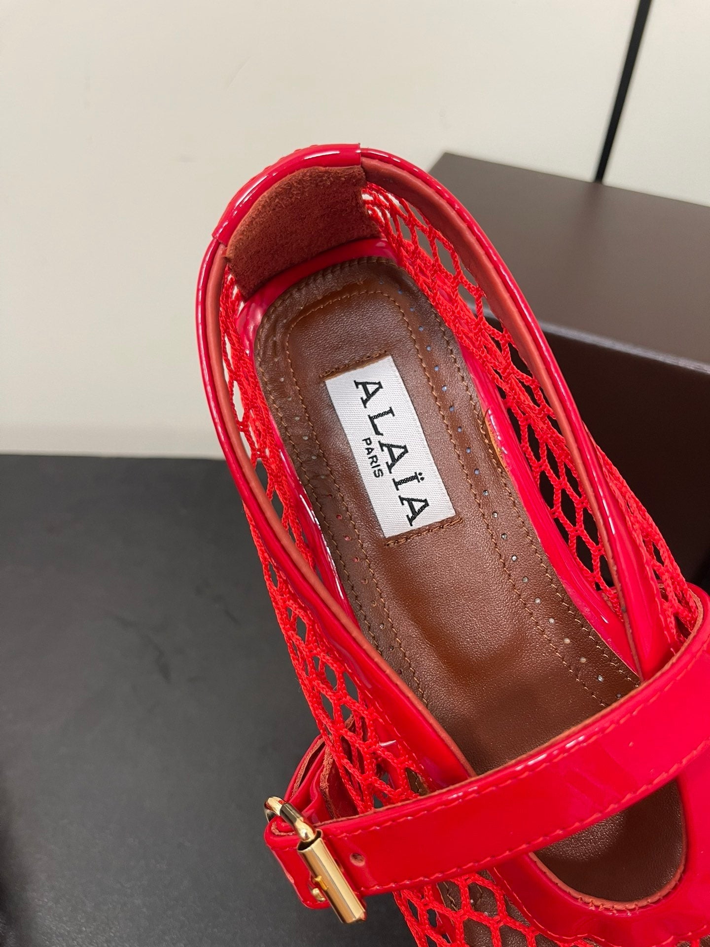 ALAIA BALLET FLATS IN CHERRY RED MESH FISHNET