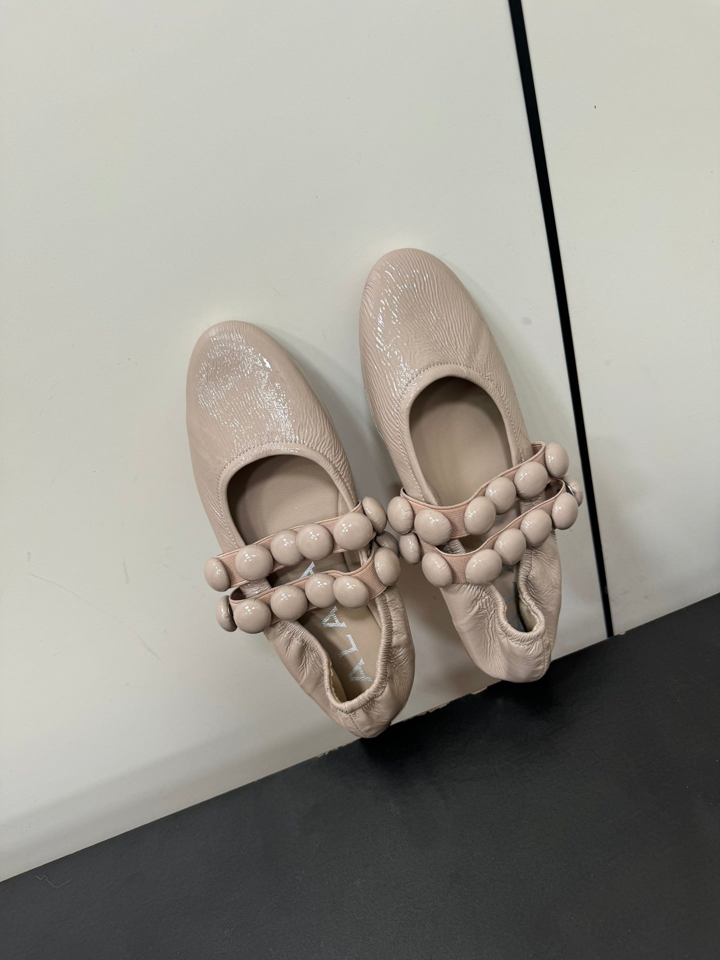 ALAIA SPHERE BALLET FLATS IN ALMOND BEIGE LAMBSKIN