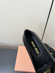 LOAFERS WITH BOW IN BLACK SHEEPSKIN