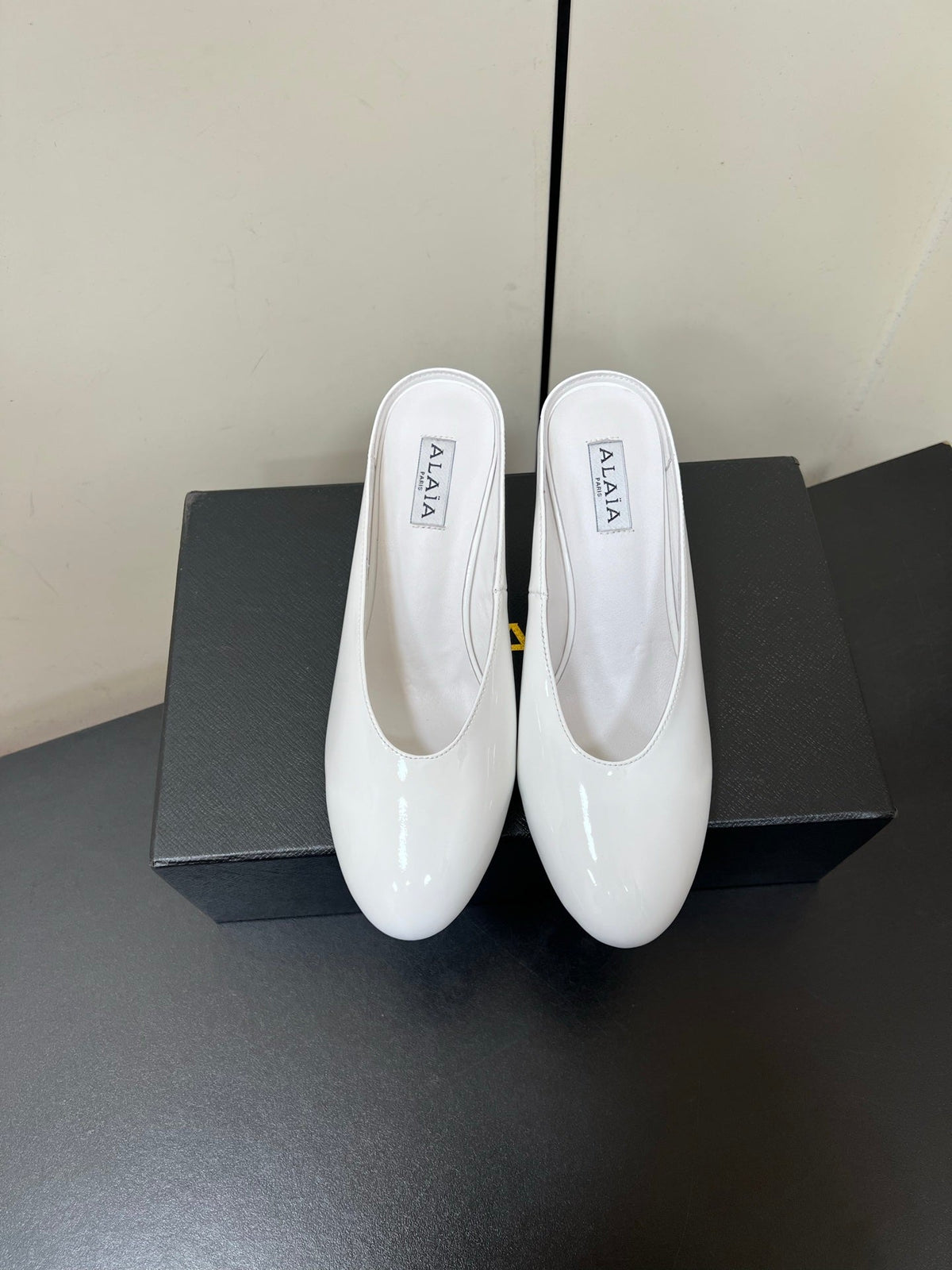 ALAIA WEDGE MULES 25S IN CREAM WHITE LAMBSKIN