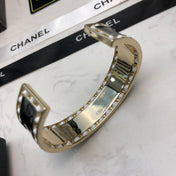 CHANEL 26S CHANEL LOGO BLACK ENAMEL STATEMENT CUFF BRACELET IN GOLD METAL 630834