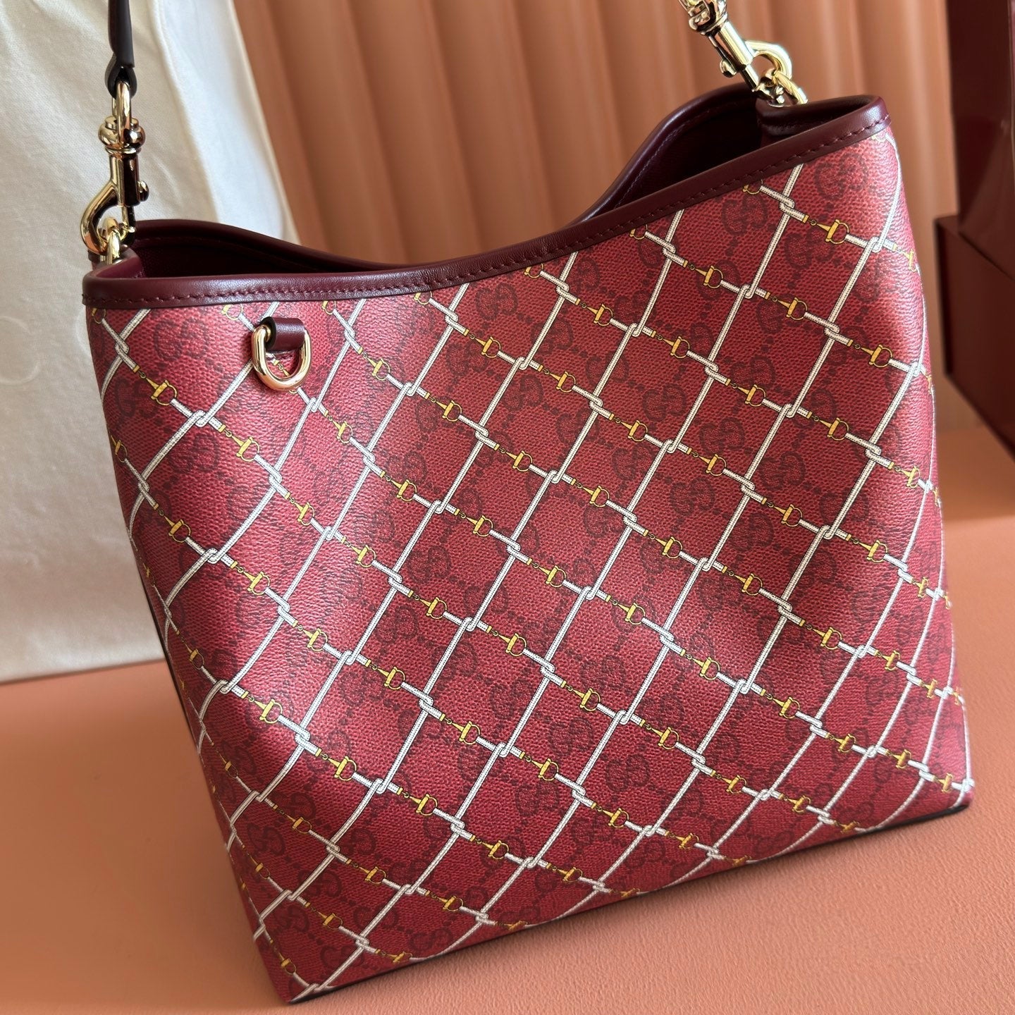 GUCCI 26S GG EMBLEM BUCKET BAG 25 IN DARK RED COATED FABRIC