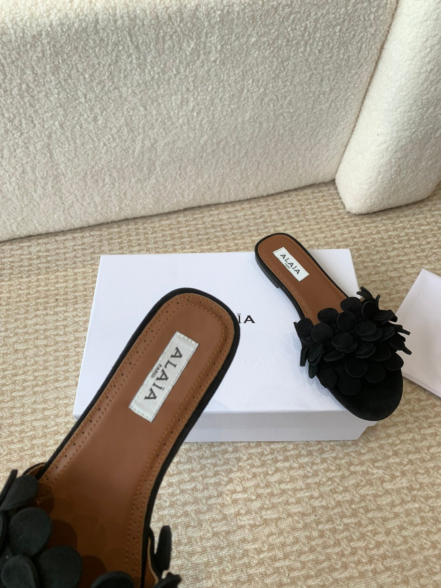 ALAIA FLAT MULE IN BLACK SUEDE