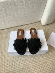 ALAIA FLAT MULE IN BLACK SUEDE