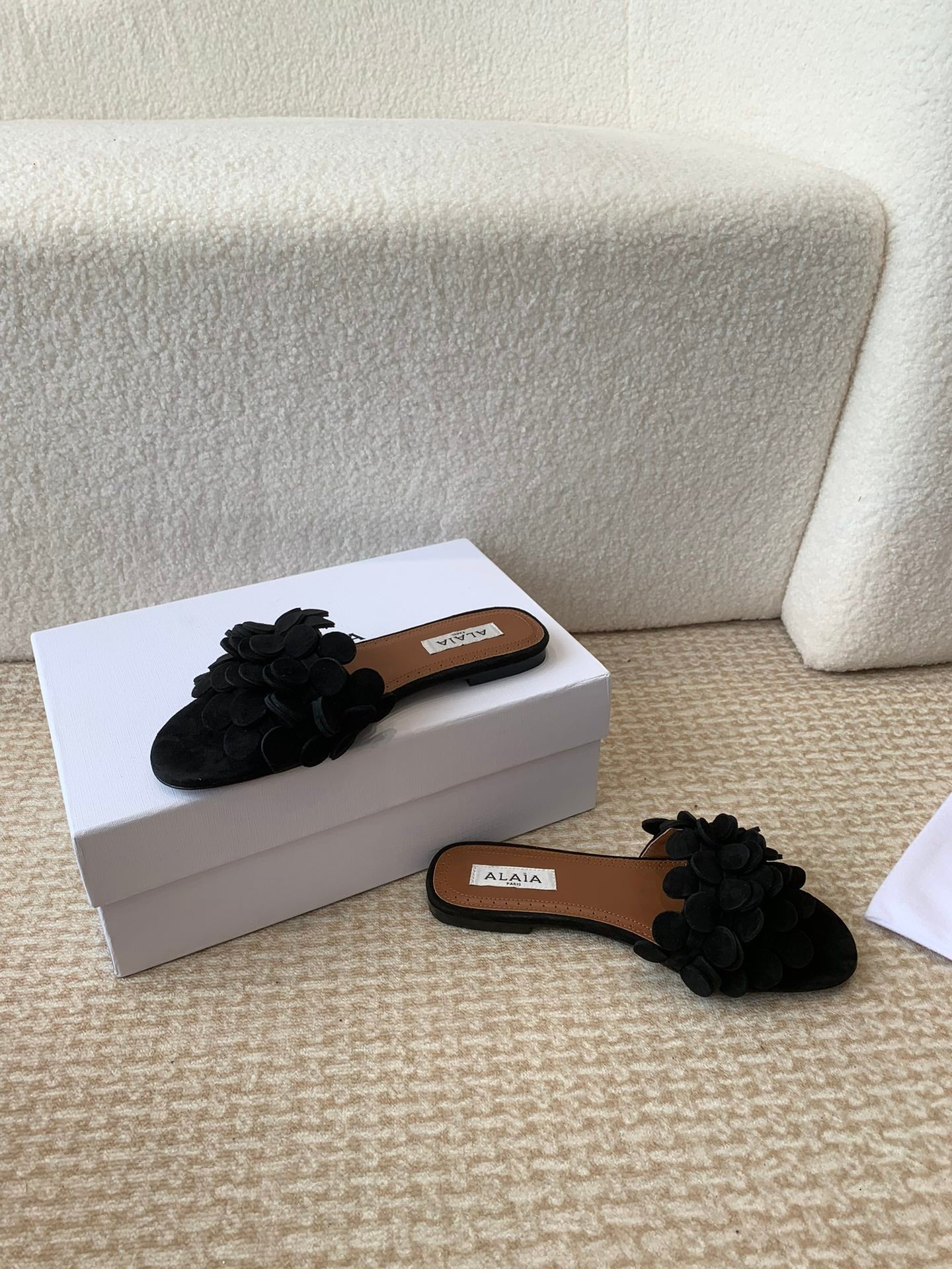 ALAIA FLAT MULE IN BLACK SUEDE