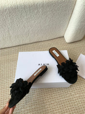ALAIA FLAT MULE IN BLACK SUEDE