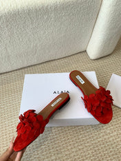 ALAIA FLAT MULE IN CHERRY RED SUEDE