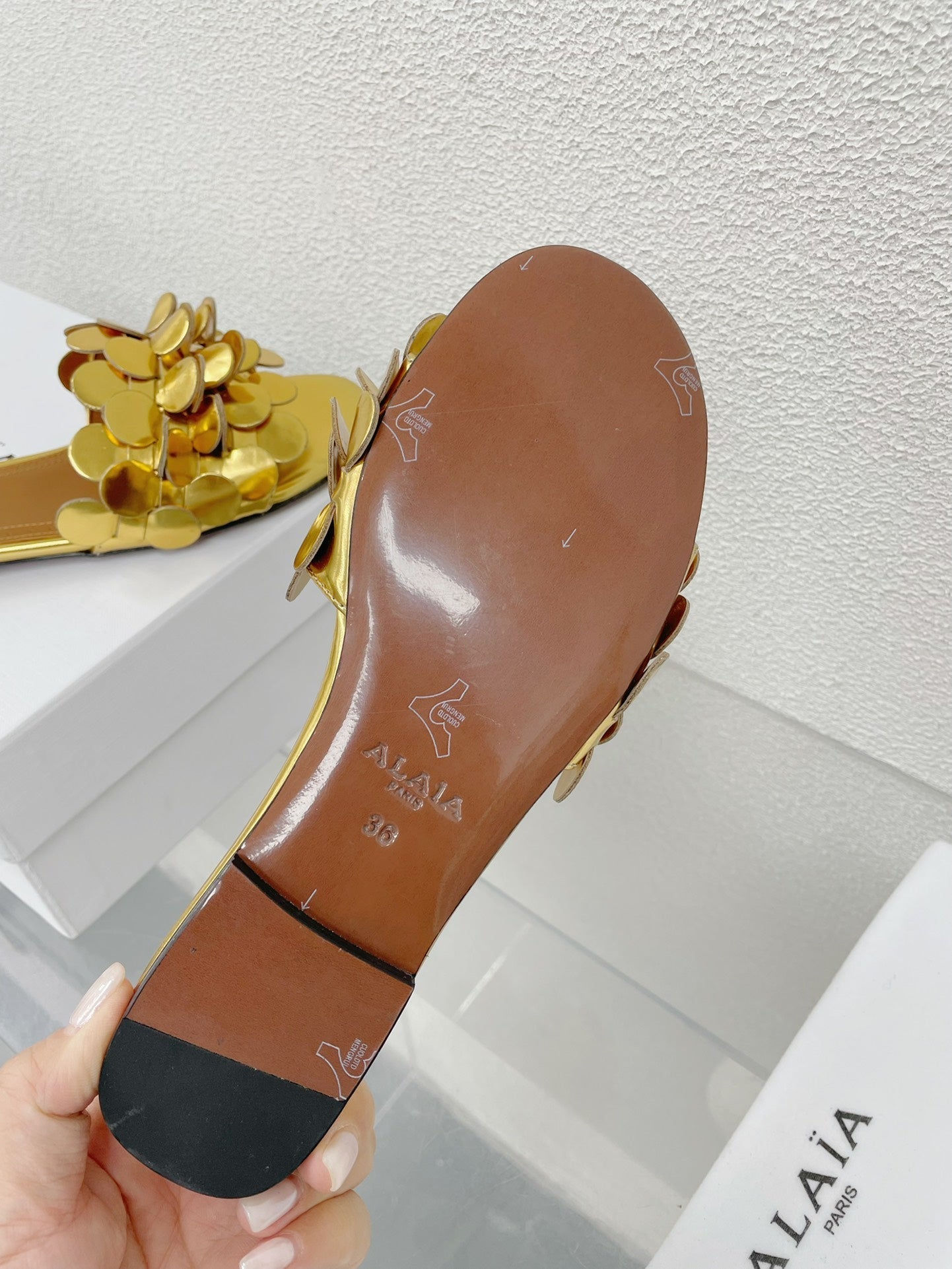 ALAIA FLAT MULE IN GOLDEN GLOSSY LAMBSKIN