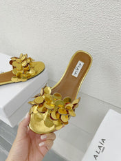 ALAIA FLAT MULE IN GOLDEN GLOSSY LAMBSKIN