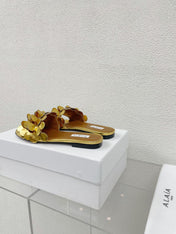 ALAIA FLAT MULE IN GOLDEN GLOSSY LAMBSKIN