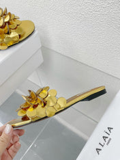 ALAIA FLAT MULE IN GOLDEN GLOSSY LAMBSKIN