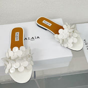 ALAIA FLAT MULE IN WHITE GLOSSY LAMBSKIN