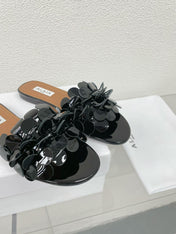 ALAIA FLAT MULE IN BLACK GLOSSY LAMBSKIN