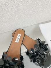 ALAIA FLAT MULE IN BLACK GLOSSY LAMBSKIN