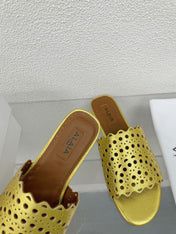 ALAIA VIENNE FLAT MULES IN GOLDEN LAMBSKIN
