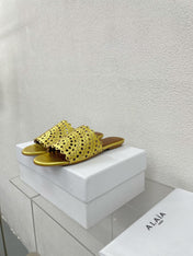 ALAIA VIENNE FLAT MULES IN GOLDEN LAMBSKIN