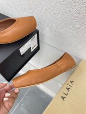 ALAIA BALLET FLATS IN COPPER BROWN CALFSKIN
