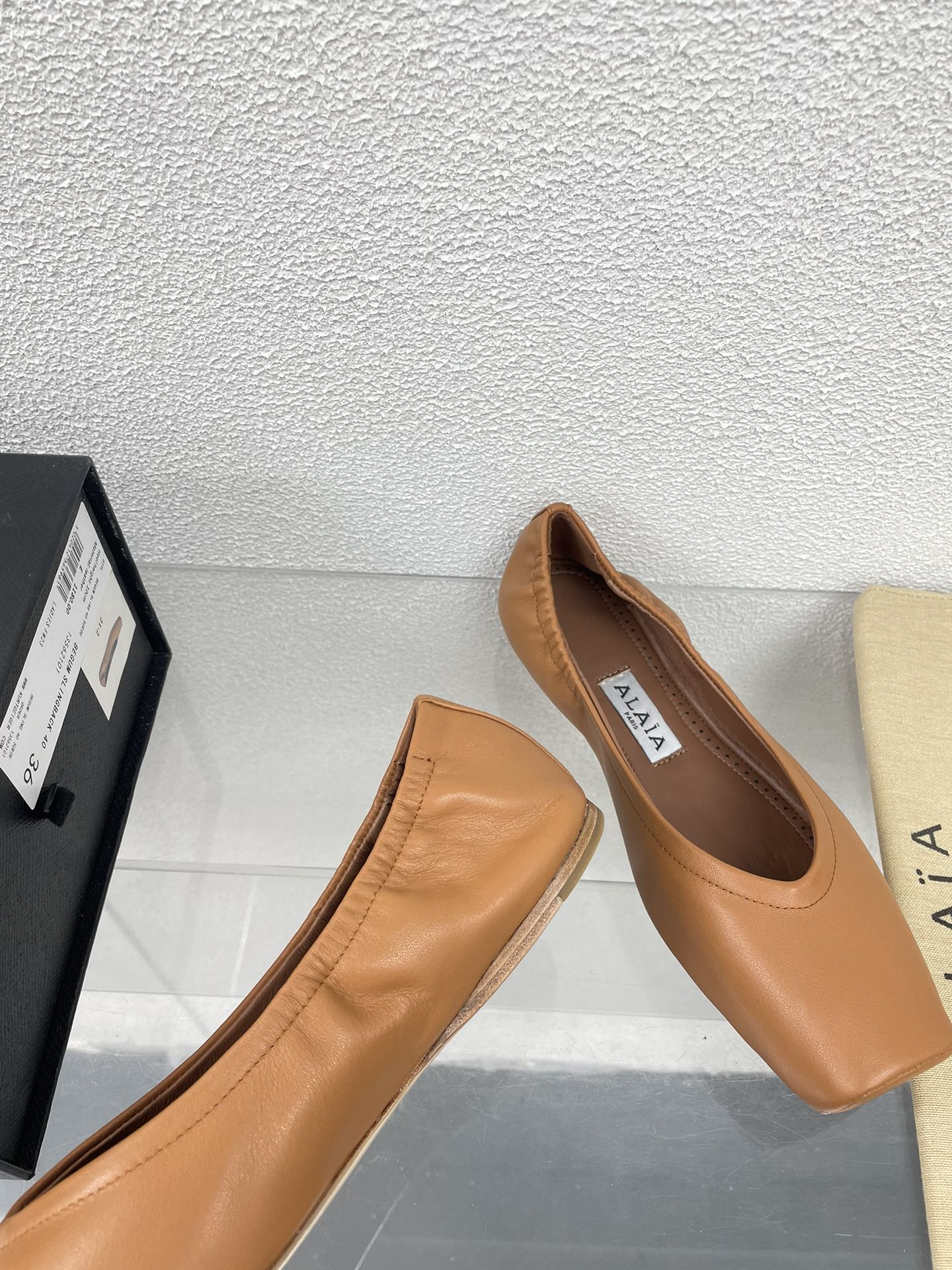ALAIA BALLET FLATS IN COPPER BROWN CALFSKIN