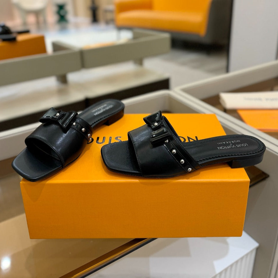 LV X TM 6AM FLAT MULE IN BLACK CALFSKIN