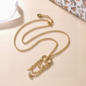 CD 26S PEARL CHAIN DROP LOGO NECKLACE IN GOLD TONE METAL WITH WHITE RESIN PEARL & CRYSTAL 631060