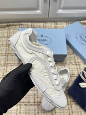 PRADA 26S LOW TOP SNEAKERS IN WHITE NYLON AND SUEDE