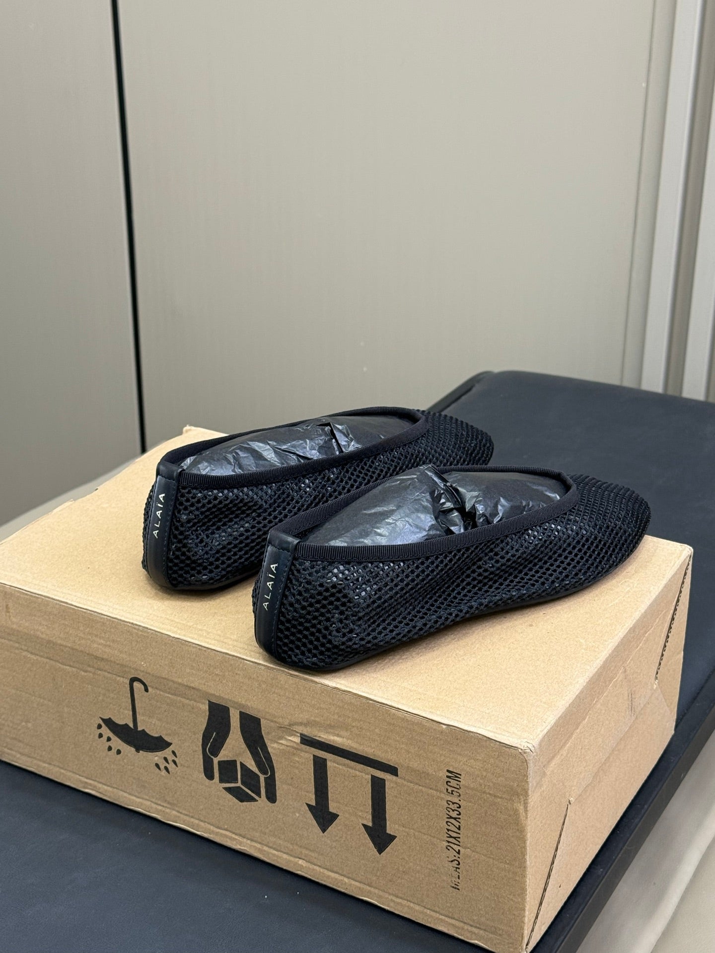 ALAIA FISHNET MESH BALLET FLATS 25S IN BLACK FABRIC