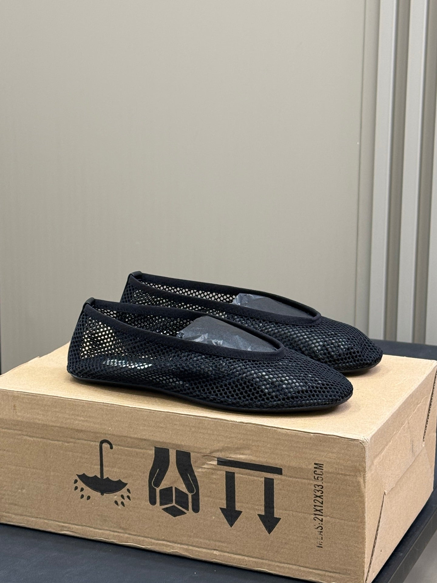 ALAIA FISHNET MESH BALLET FLATS 25S IN BLACK FABRIC